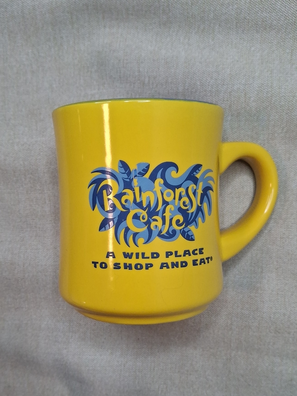 RAINFOREST Yellow Ceramic Cafe Mug with Blue Logo